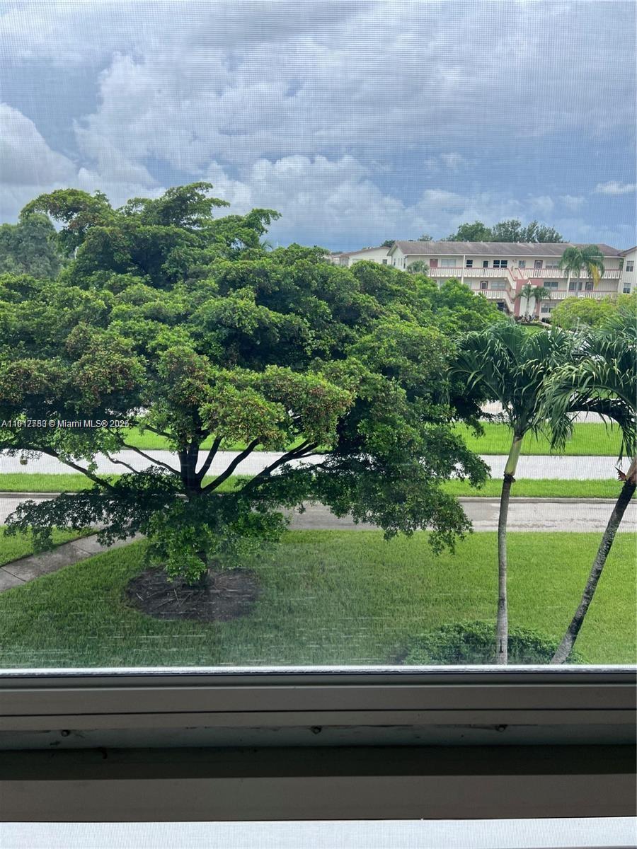 155 Suffolk F, Unit D Boca Raton, FL 33434 - Photo 17 of 22 a view of a yard from a window
