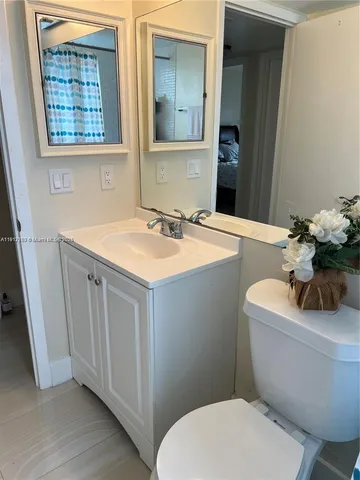 a bathroom with a toilet a sink and a mirror