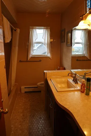 a bathroom with a sink a mirror and a window