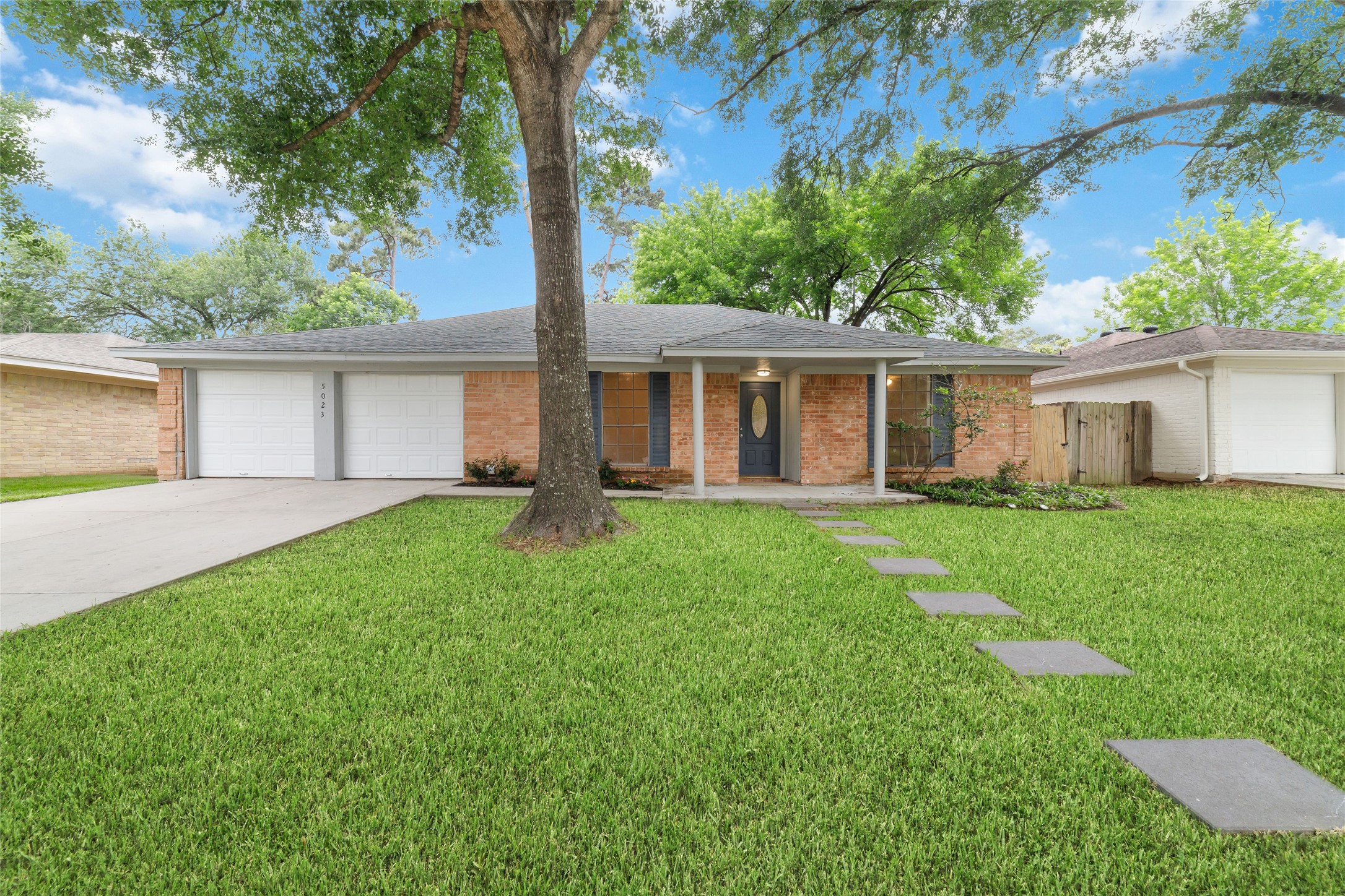 5023 Monteith Drive Spring, TX 77373 - Photo 1 of 20 Charming front exterior with a welcoming covered entry, mature trees, and large front windows that bring in natural light and create an inviting first impression.