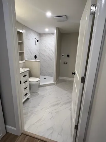 a view of a hallway with closet and wooden floor