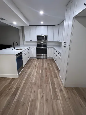 a kitchen with kitchen island sink stove and refrigerator