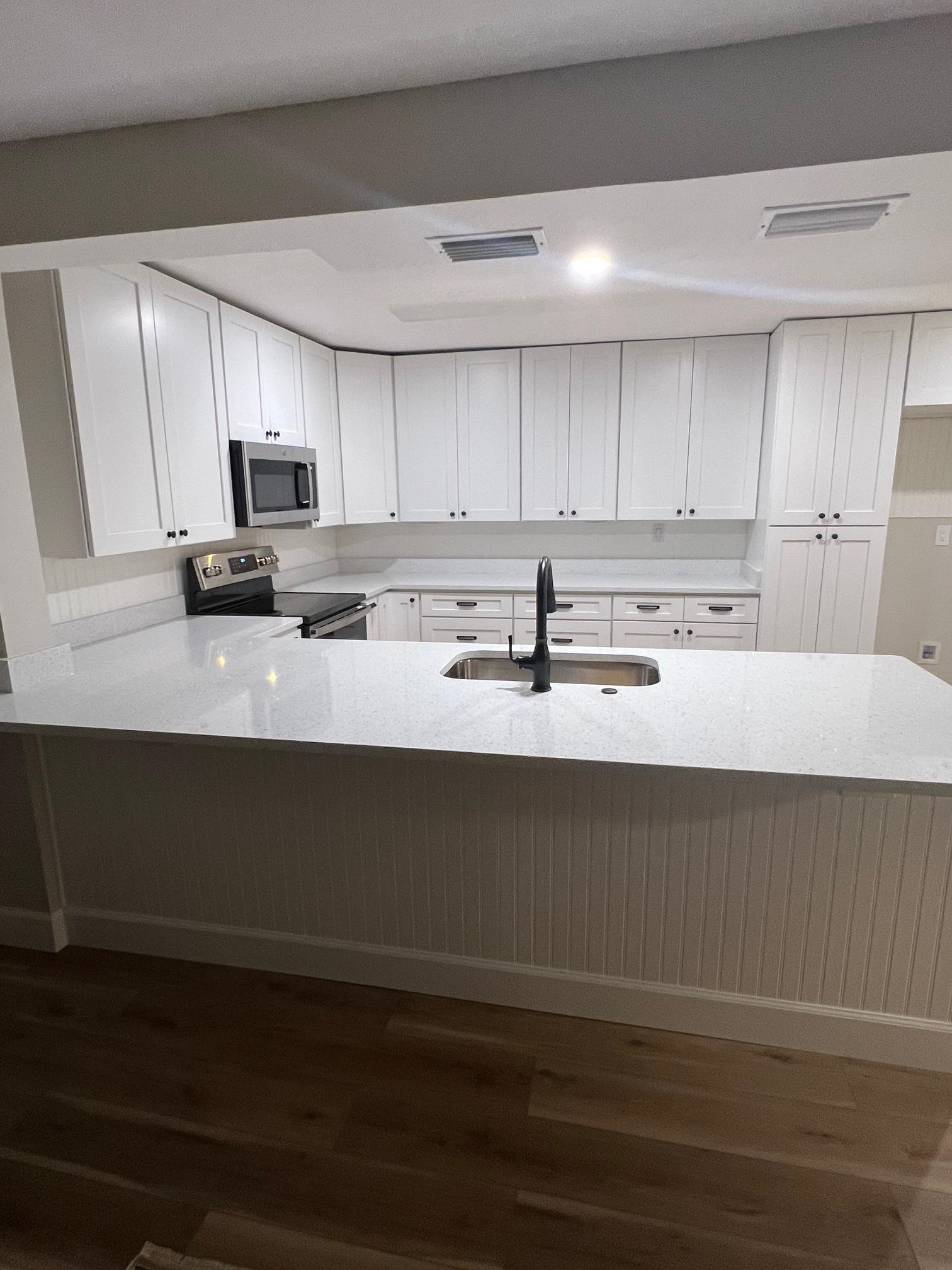 41 1/2 Madeore Street St. Augustine, FL 32084 - Photo 20 of 24 a kitchen with stainless steel appliances a sink stove and cabinets