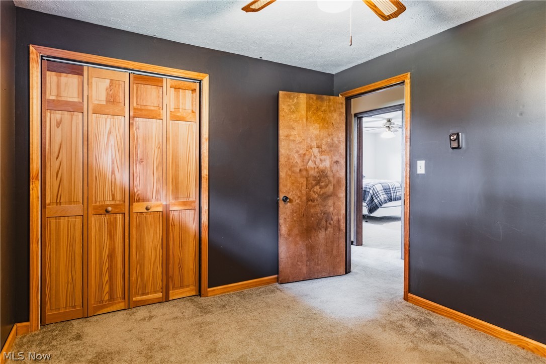 279 Spence Road Belpre, OH 45714 - Photo 16 of 40 Unfurnished bedroom featuring ceiling fan, a textured ceiling, and light colored carpet