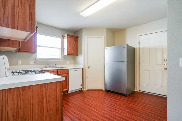 a kitchen with a refrigerator and a sink
