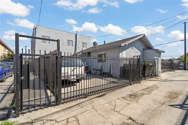 a view of a house with a wooden fence