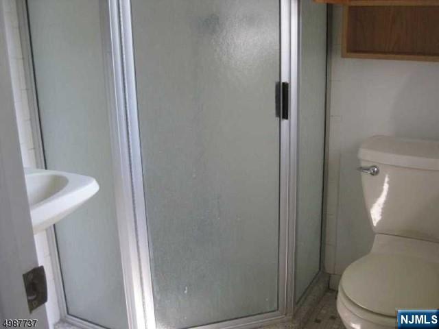 552 Stevens Avenue Ridgewood, NJ 07450 - Photo 19 of 43 a white toilet sitting next to a shower