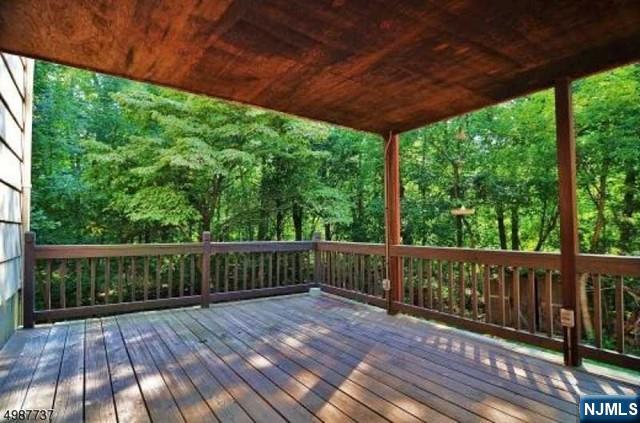 552 Stevens Avenue Ridgewood, NJ 07450 - Photo 21 of 43 a view of deck with wooden floor and fence with a garden