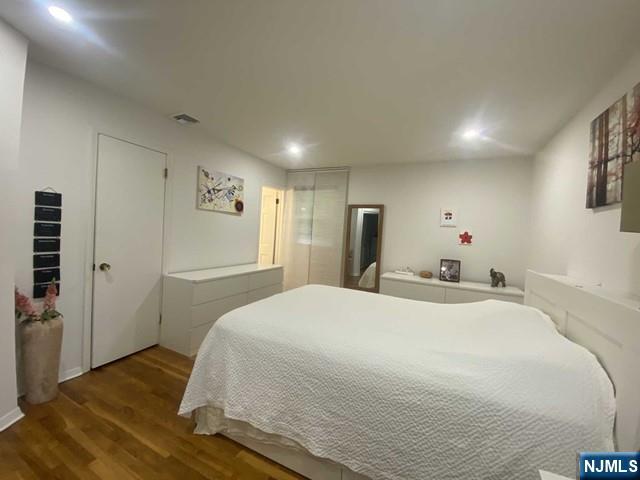 552 Stevens Avenue Ridgewood, NJ 07450 - Photo 28 of 43 a bedroom with a bed and a refrigerator