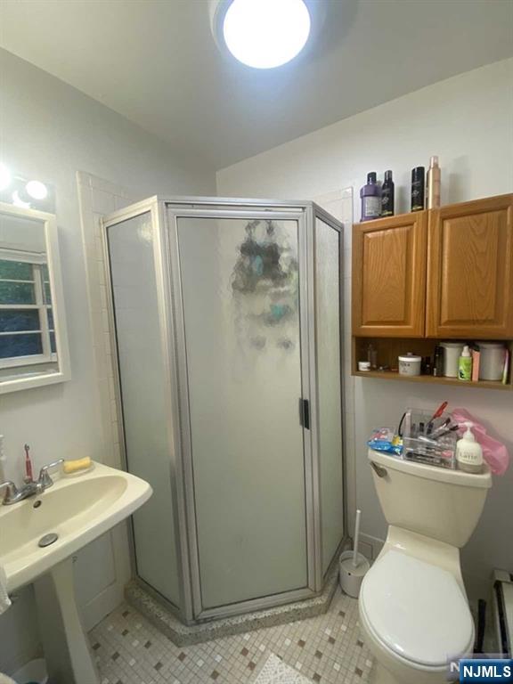 552 Stevens Avenue Ridgewood, NJ 07450 - Photo 29 of 43 a bathroom with a sink toilet and shower