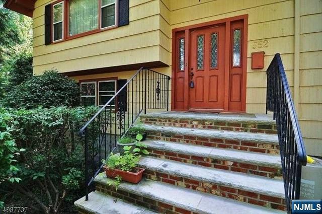 552 Stevens Avenue Ridgewood, NJ 07450 - Photo 3 of 43 a front view of a house with a garden