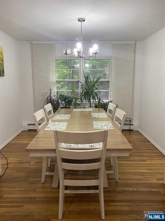 552 Stevens Avenue Ridgewood, NJ 07450 - Photo 34 of 43 a view of a dining room with furniture a chandelier and wooden floor