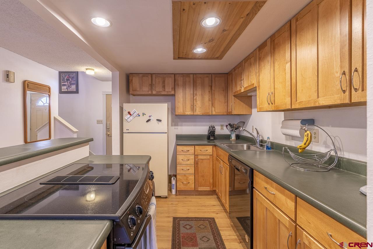 1900 Florida Road, Unit A6 Durango, CO 81301 - Photo 2 of 25 a kitchen with stainless steel appliances granite countertop a sink stove and refrigerator