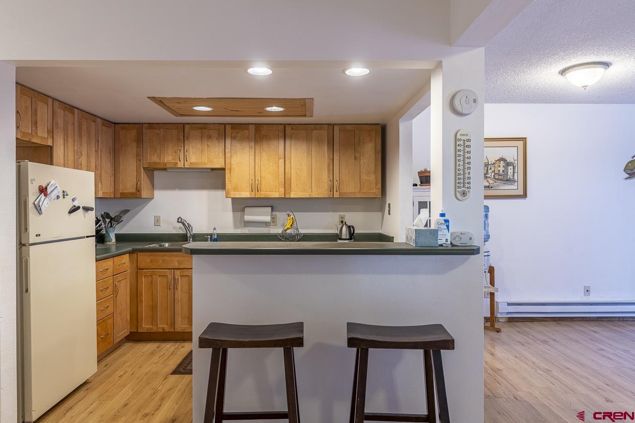 1900 Florida Road, Unit A6 Durango, CO 81301 - Photo 3 of 25 a kitchen with stainless steel appliances a sink a stove a refrigerator cabinets and wooden floor