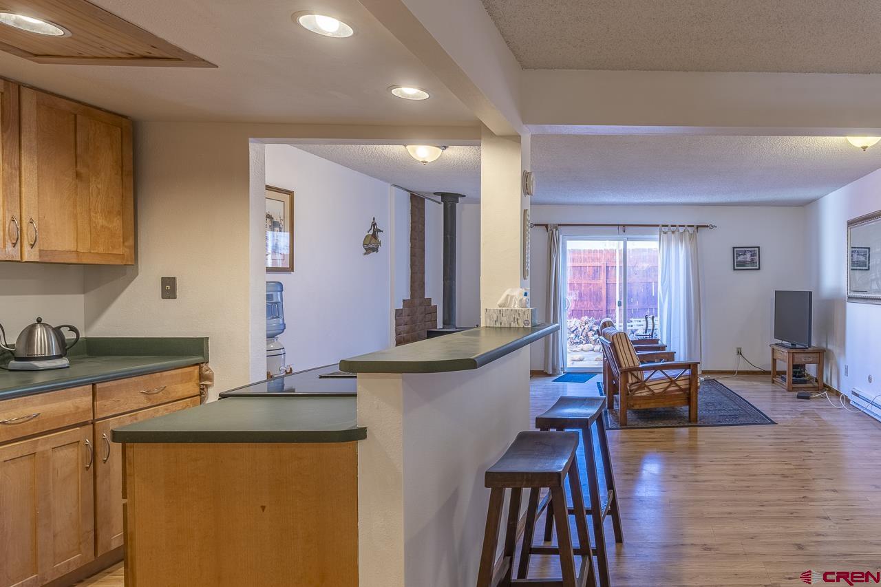 1900 Florida Road, Unit A6 Durango, CO 81301 - Photo 7 of 25 a living room with granite countertop kitchen island stainless steel appliances wooden floor and sink