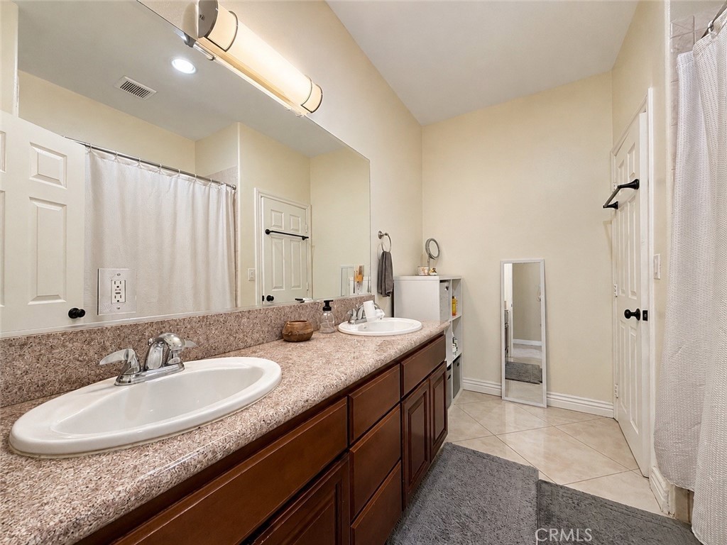 18437 Newman Avenue Riverside, CA 92508 - Photo 26 of 51 Main bathroom with double sink, tub, shower