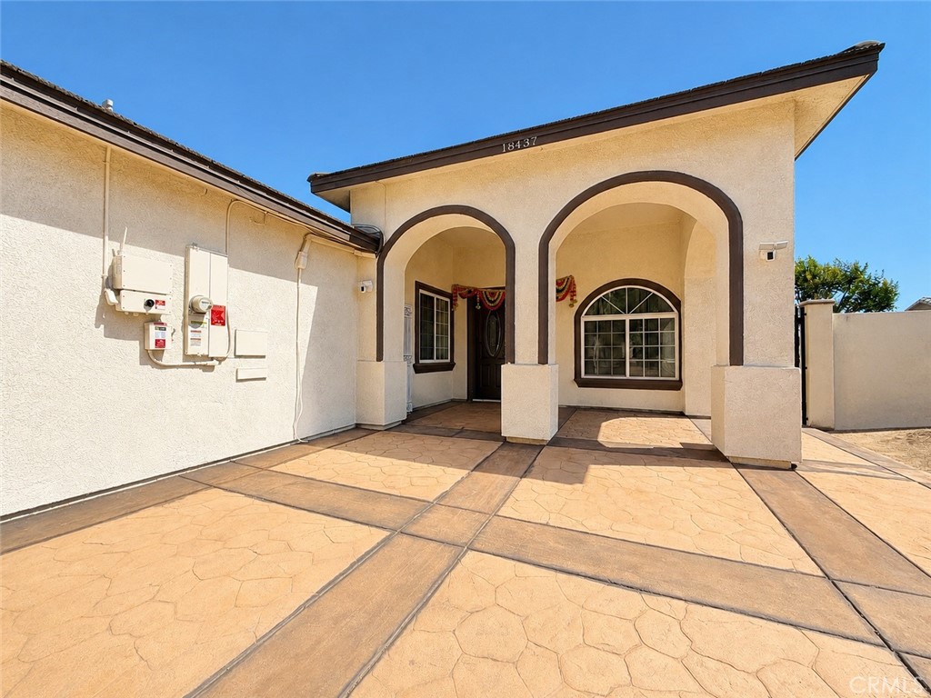 18437 Newman Avenue Riverside, CA 92508 - Photo 3 of 51 Shaded front entranceway with one of the garages to the left of the photo