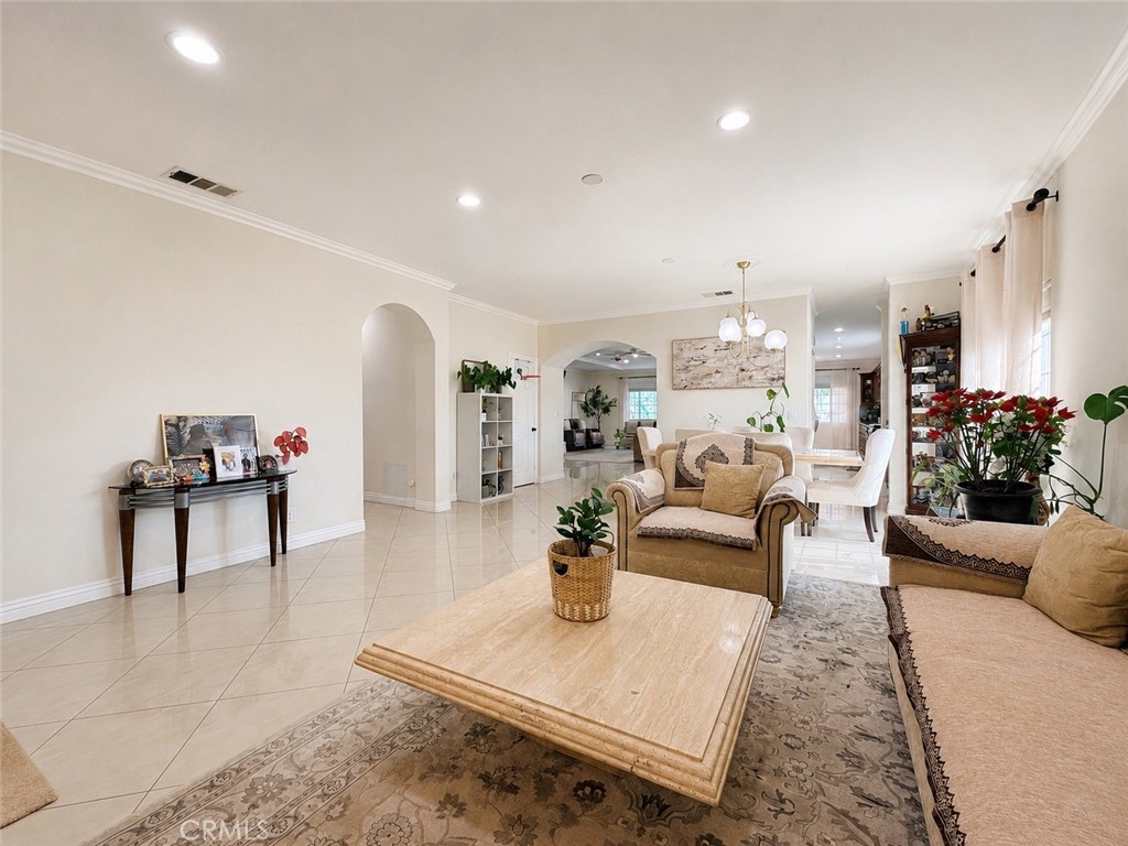 18437 Newman Avenue Riverside, CA 92508 - Photo 5 of 51 Living room with arched door to the hallway of the bedrooms and small doorway to kitchen/Butler's pantry/walk-in pantry