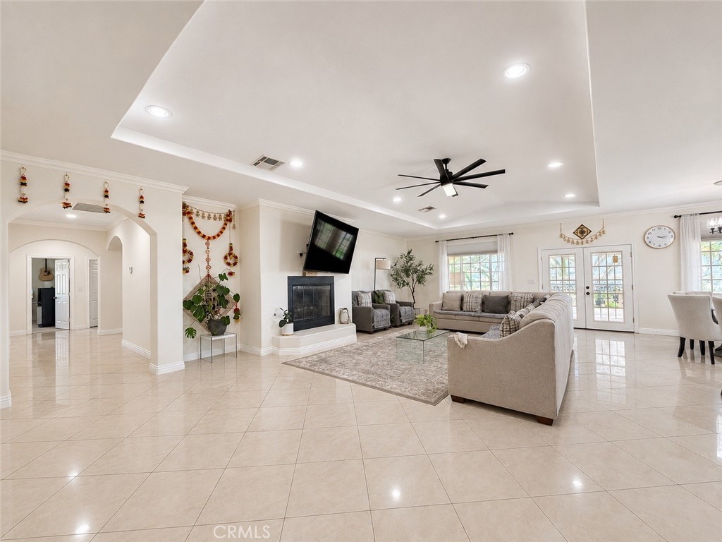 18437 Newman Avenue Riverside, CA 92508 - Photo 7 of 51 Elegant and expansive family room with fireplace, French doors to backyard shaded patio, and arched door to hallway leading to bedrooms