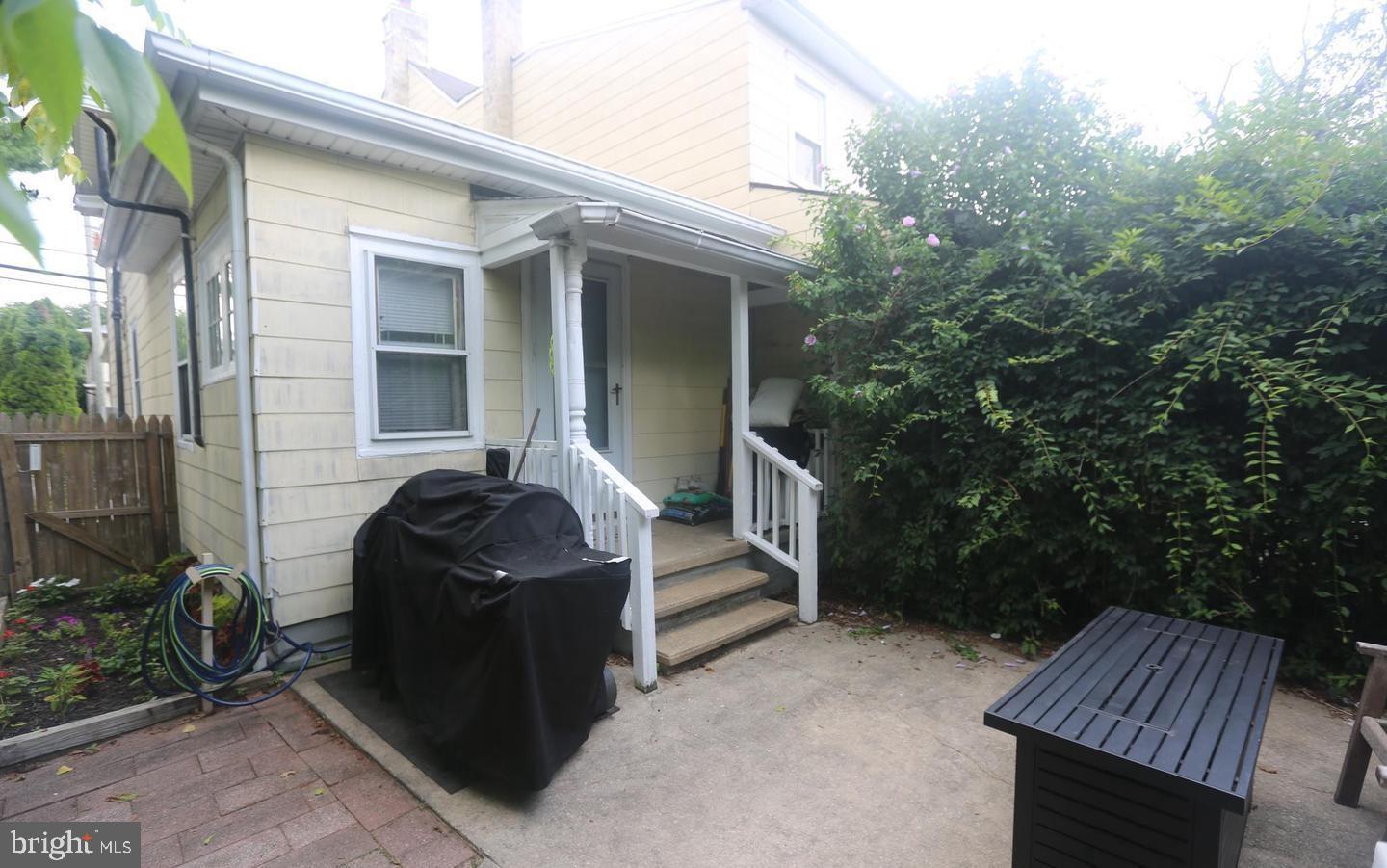 116 Ellis Street Glassboro, NJ 08028 - Photo 4 of 10 a front view of a house with garden and seating area