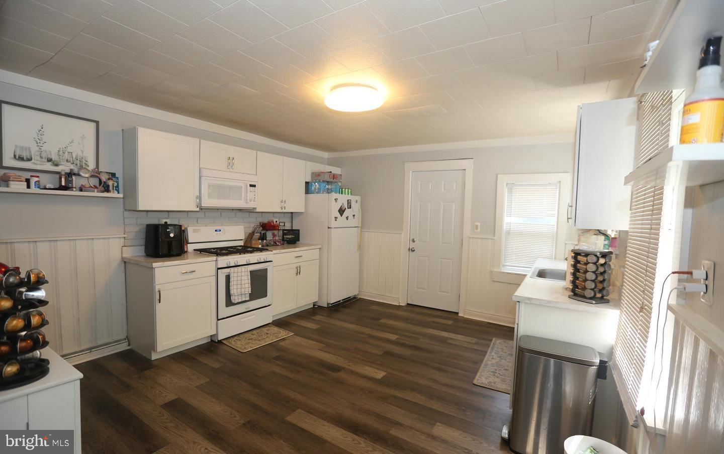 116 Ellis Street Glassboro, NJ 08028 - Photo 5 of 10 a kitchen with a refrigerator and white cabinets