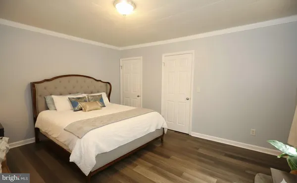 a bedroom with a bed and a night stand