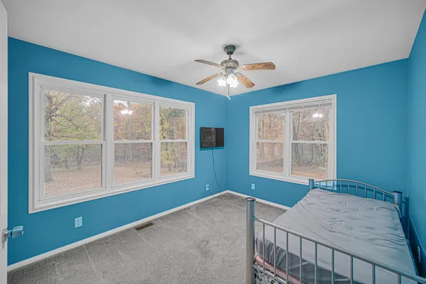 a bedroom with a bed and a window