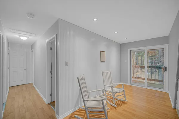 a view of a room with wooden floor and windows
