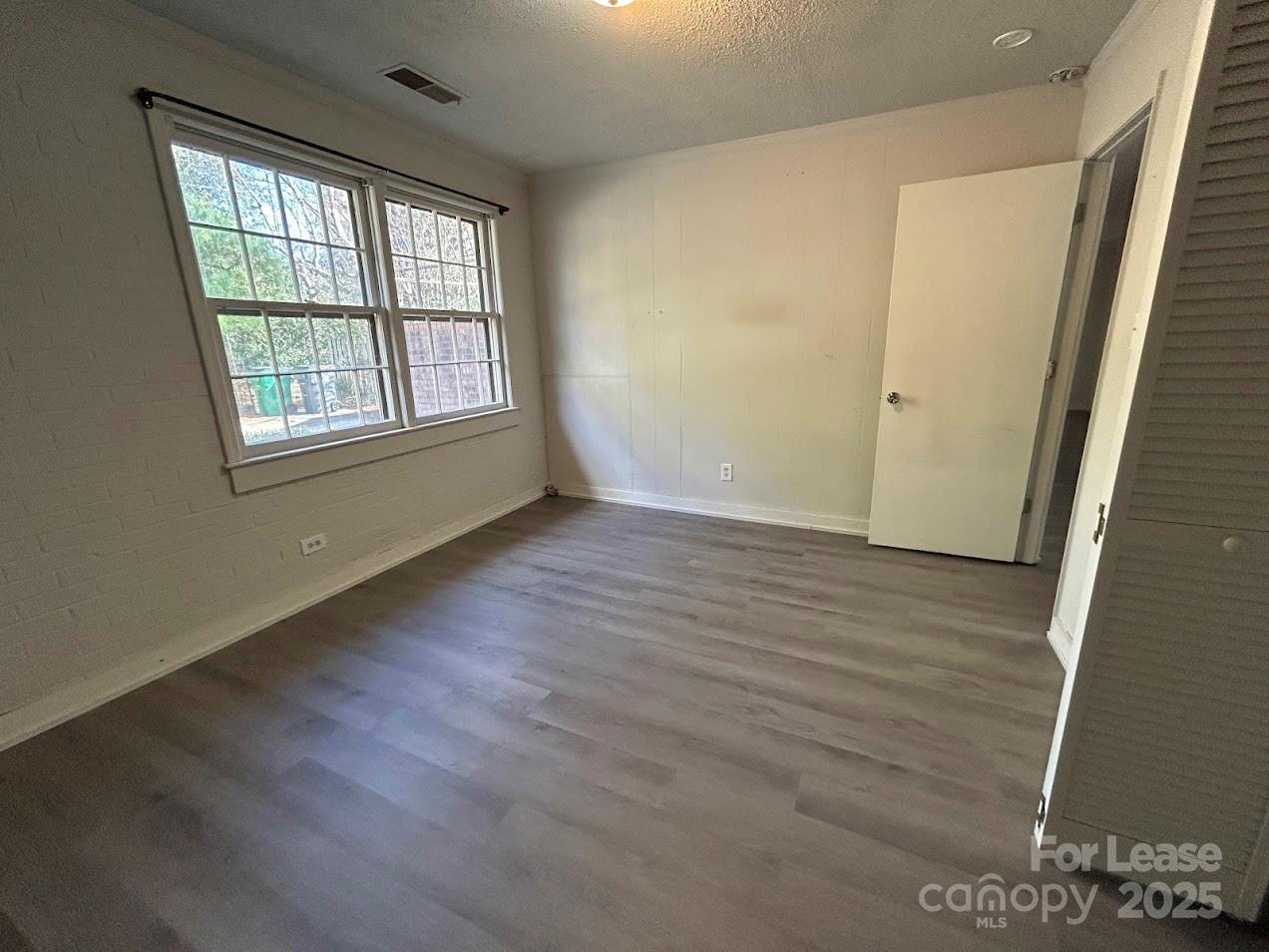 3312 Circles End Circle Charlotte, NC 28226 - Photo 12 of 22 an empty room with wooden floor and windows