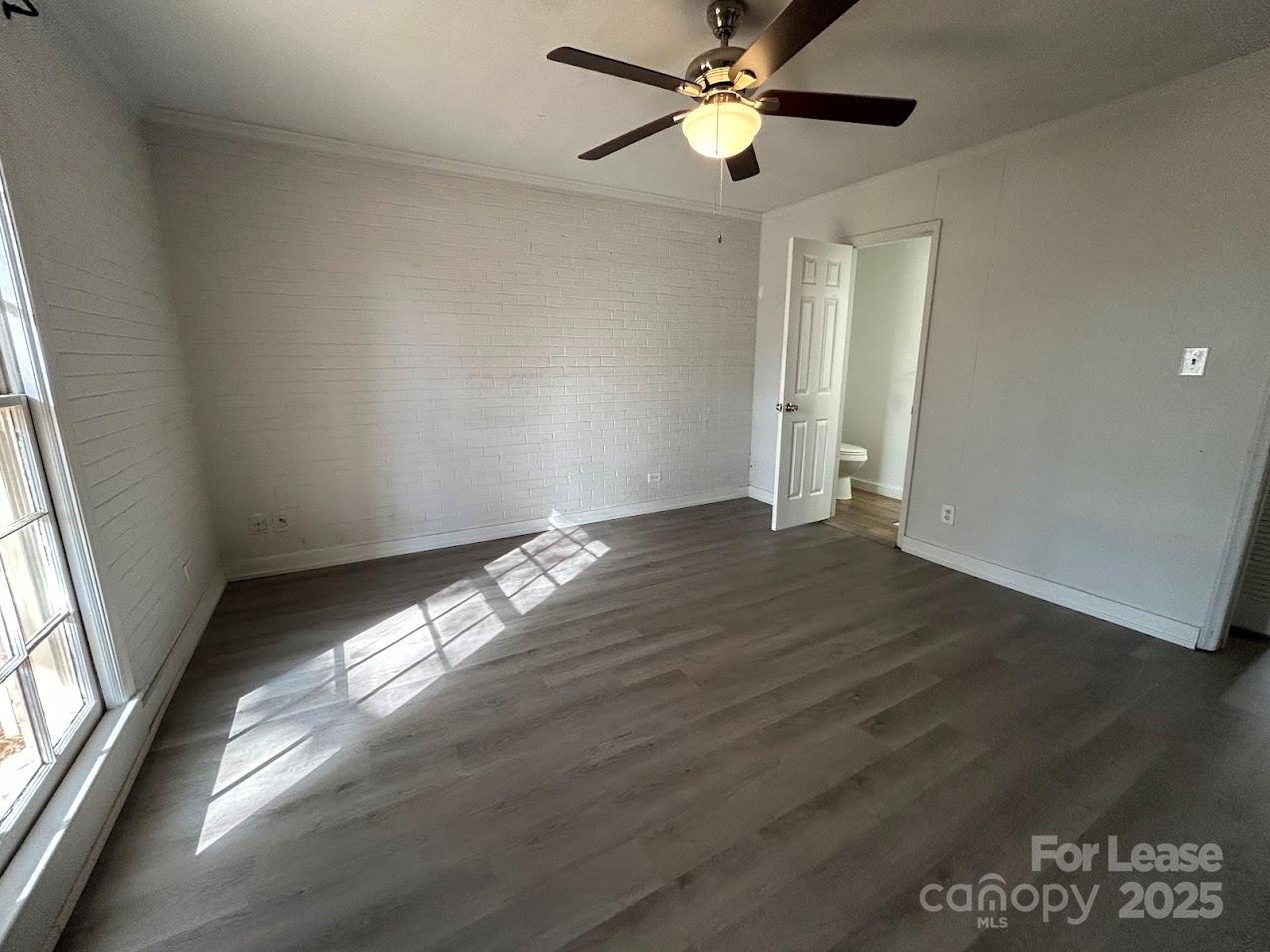 3312 Circles End Circle Charlotte, NC 28226 - Photo 16 of 22 an empty room with wooden floor fan and windows