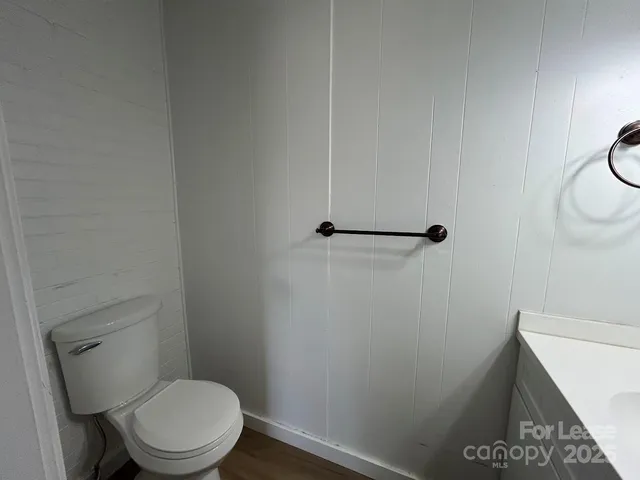 a white toilet sitting next to a shower