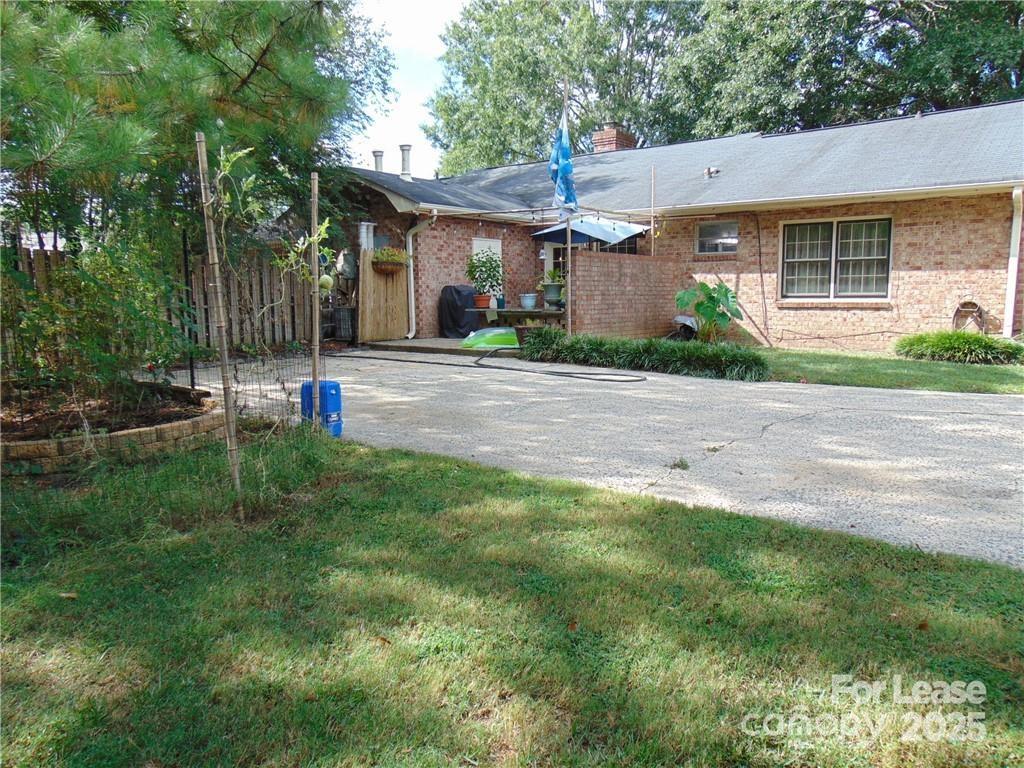 3312 Circles End Circle Charlotte, NC 28226 - Photo 21 of 22 a view of a house with a backyard and a tree