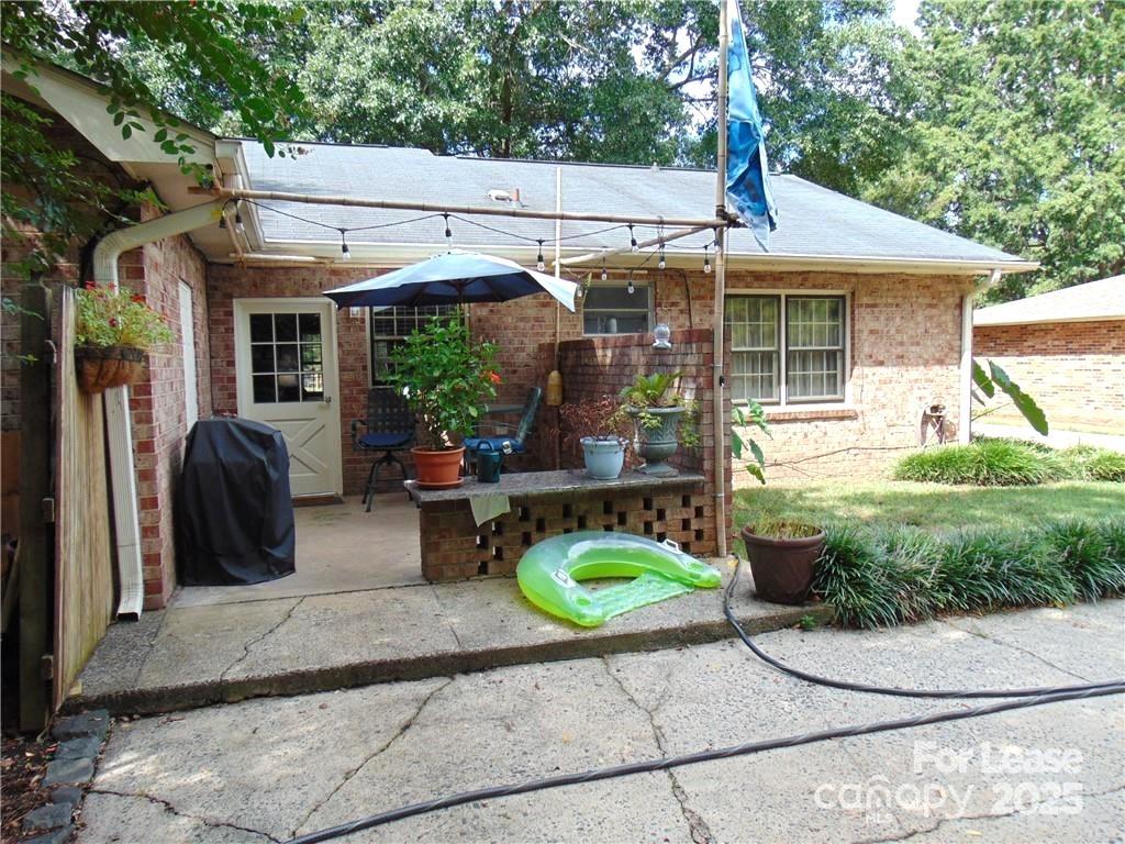 3312 Circles End Circle Charlotte, NC 28226 - Photo 22 of 22 a view of a patio with table and chairs under an umbrella