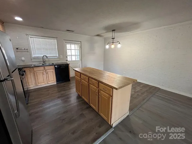 a kitchen with stainless steel appliances granite countertop a sink and stove