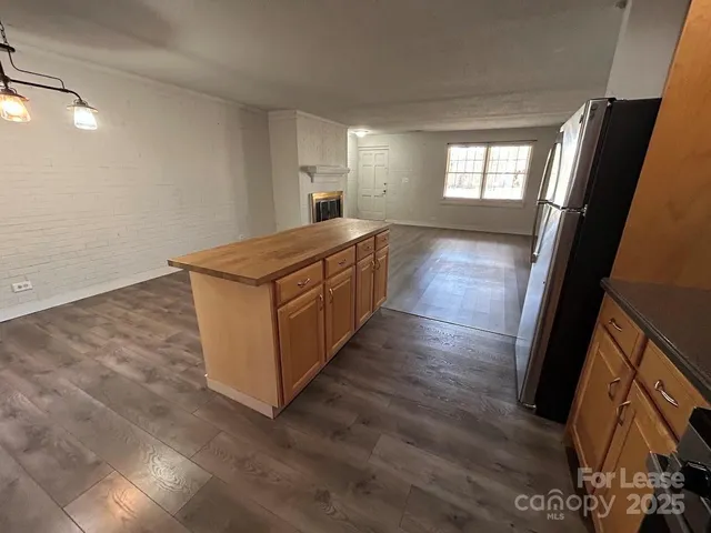 a kitchen with stainless steel appliances granite countertop a stove and a large window