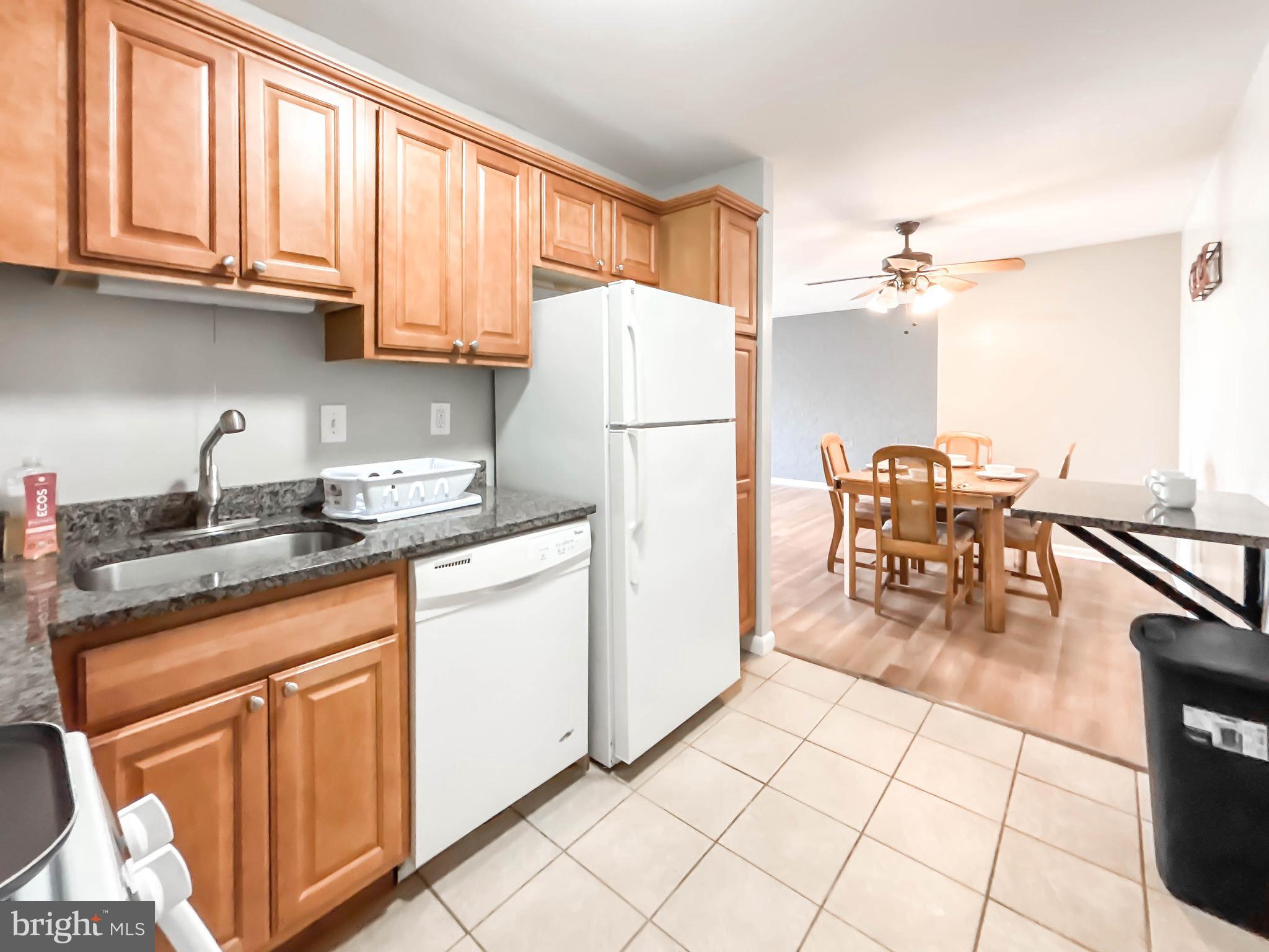 130 Slade Avenue, Unit 414 Baltimore, MD 21208 - Photo 38 of 48 a kitchen with stainless steel appliances granite countertop a refrigerator and a stove top oven