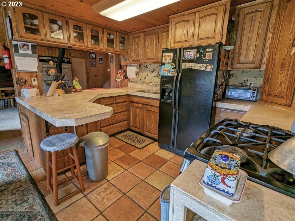 72769 Snowdon Road Rhododendron, OR 97049 - Photo 28 of 48 a kitchen with a sink a stove and a refrigerator