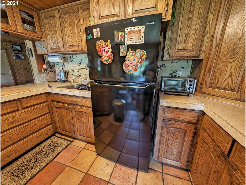 72769 Snowdon Road Rhododendron, OR 97049 - Photo 29 of 48 a kitchen with stainless steel appliances granite countertop a stove and a sink