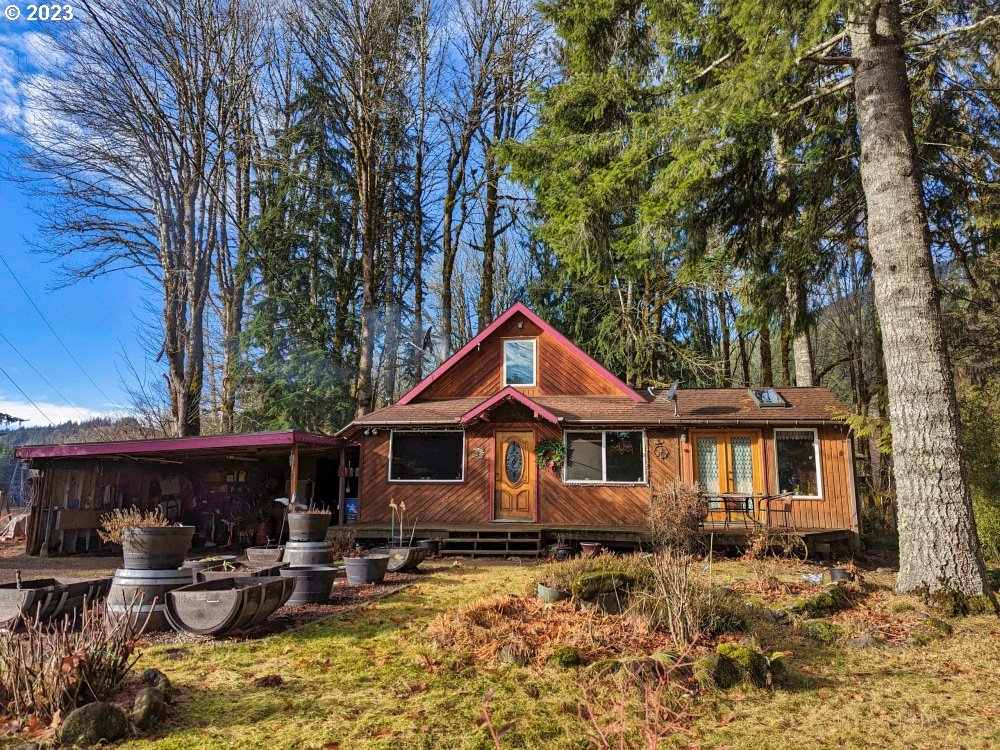 72769 Snowdon Road Rhododendron, OR 97049 - Photo 5 of 48 a front view of a house with yard outdoor seating and barbeque oven