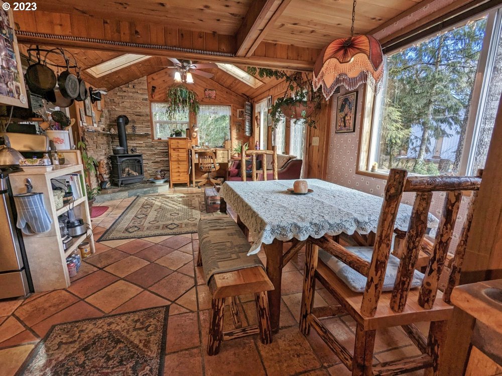 72769 Snowdon Road Rhododendron, OR 97049 - Photo 9 of 48 a view of a patio with table and chairs under an umbrella