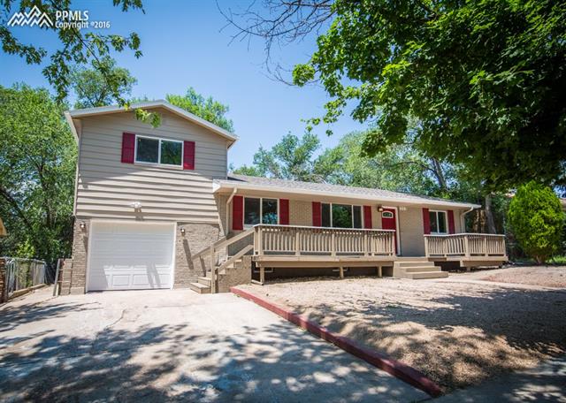408 Placid Road Colorado Springs, CO 80910 - Photo 2 of 36 Street view of the home. Notice the two porches on the front of the home. There are mature trees on and around the property!