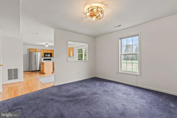 an empty room with a empty space and windows