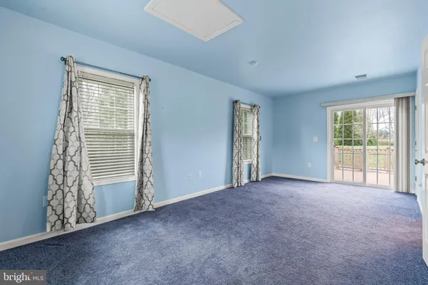 a view of an empty room with windows