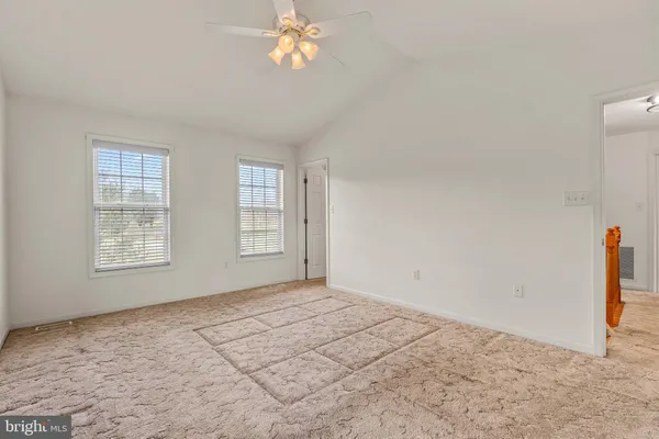 a view of an empty room and closet area