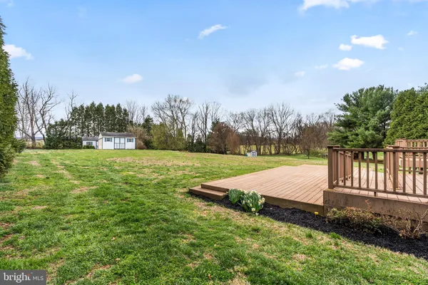 a view of a white house with a yard and plants