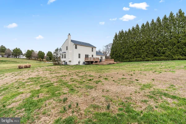 a big house with a big yard and large trees