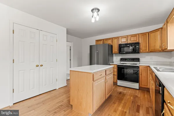 a kitchen with granite countertop a stove top oven and cabinets