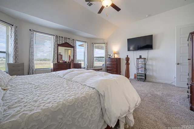 a spacious bathroom with a sink a bathtub and a double vanity