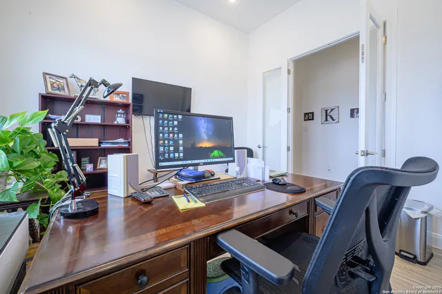 a view of a room with furniture and wooden floor
