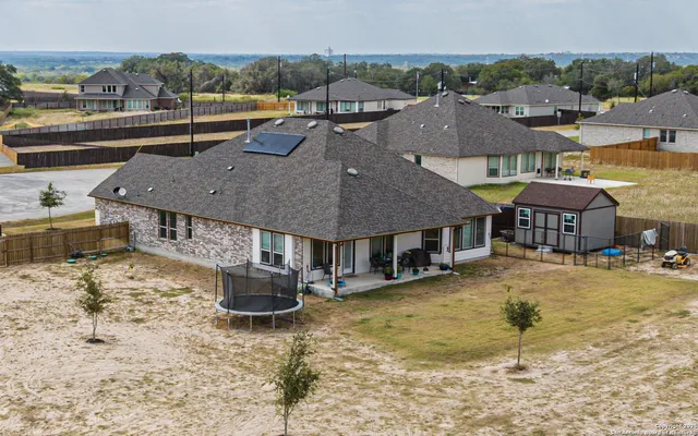 a view of a house with swimming pool and porch
